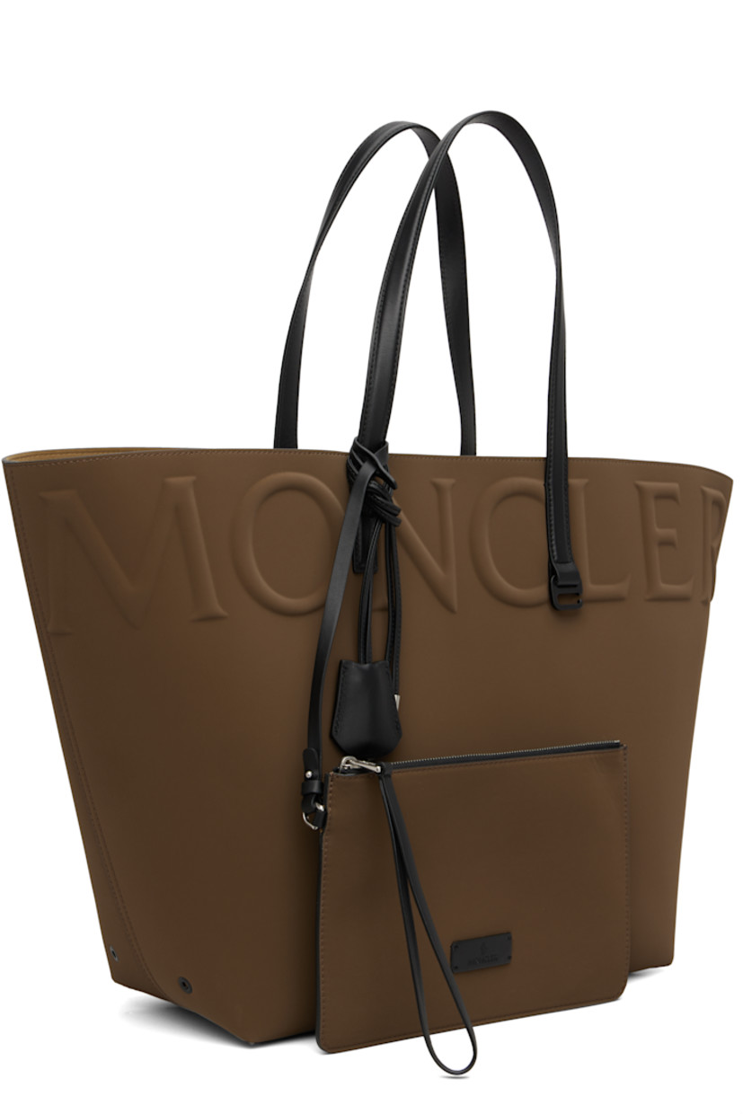 Twill tote.

· Fixed buffed calfskin shoulder straps
· Detachable zip pouch and keyring at shoulder strap
· Logo embossed at face
· Metal eyelets at sides
· Faux-suede lining
· H15" x W24" x D7"

Supplier color: Brown