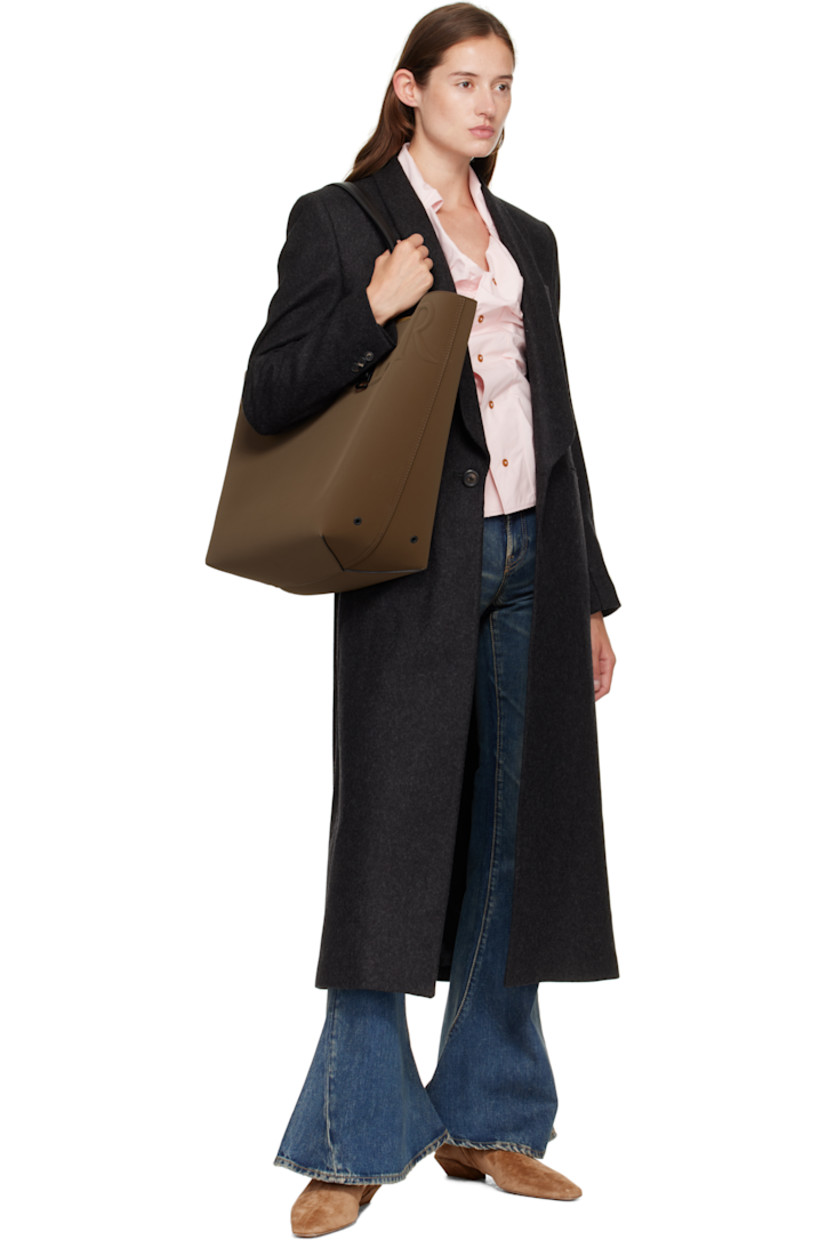 Twill tote.

· Fixed buffed calfskin shoulder straps
· Detachable zip pouch and keyring at shoulder strap
· Logo embossed at face
· Metal eyelets at sides
· Faux-suede lining
· H15" x W24" x D7"

Supplier color: Brown