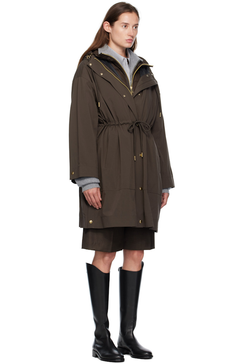 Plain-woven nylon and satin trench coat.

· Drawstring at hood
· Concealed two-way zip closure
· Press-stud placket 
· Self-tie drawstring and welt pockets at waist
· Press-stud vent at side seams
· Dropped shoulders
· Logo patch at sleeve
· Adjustable press-stud cuffs
· Detachable down-filled quilted vest-style underlay 

Supplier color: Brown

Fill: 90% goose down, 10% goose feather.