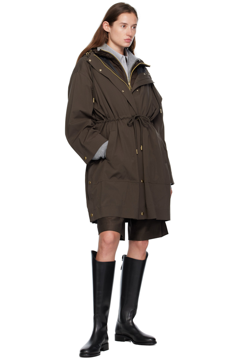 Plain-woven nylon and satin trench coat.

· Drawstring at hood
· Concealed two-way zip closure
· Press-stud placket 
· Self-tie drawstring and welt pockets at waist
· Press-stud vent at side seams
· Dropped shoulders
· Logo patch at sleeve
· Adjustable press-stud cuffs
· Detachable down-filled quilted vest-style underlay 

Supplier color: Brown

Fill: 90% goose down, 10% goose feather.