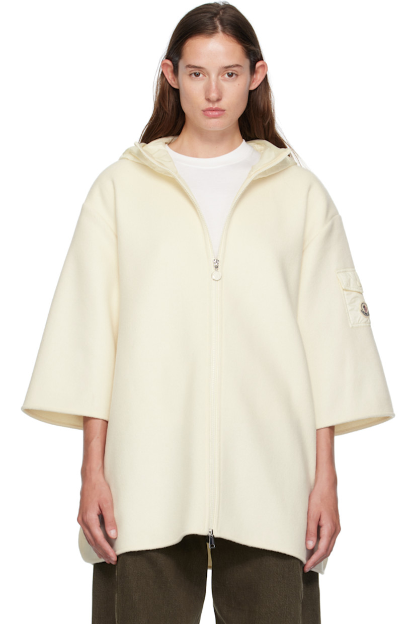 Virgin wool-blend melton cape-style jacket. 

· Quilted satin hood
· Two-way zip closure
· Press-stud fastening at open side seams
· Utility pocket and tricolor felted logo patch at sleeve

Supplier color: Beige