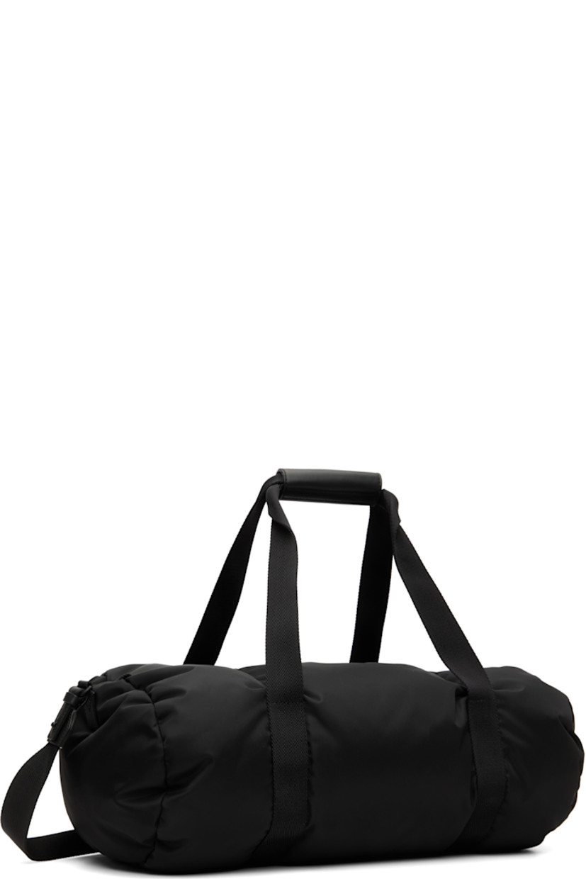 Down-filled nylon taffeta duffle bag.

· DIST-certified down
· Press-stud leather tab at carry handles
· Adjustable and detachable crossbody strap
· Logo bonded at face
· Zip closure
· Logo-engraved black hardware
· H8" x W20" x D10"

Supplier color: Black

Fill: 90% goose down, 10% goose feather.