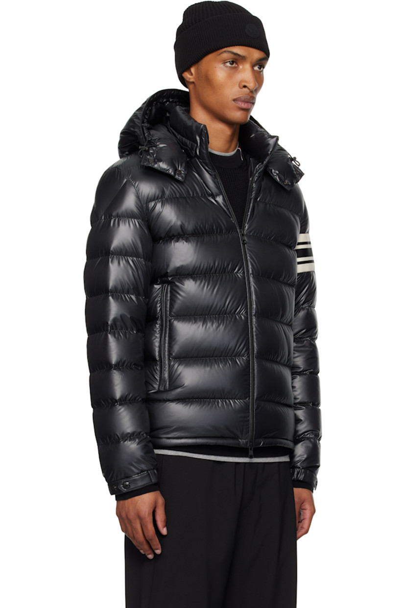 Down-filled and quilted polyester satin jacket.

· DIST-certified down
· Bungee-style drawstring at detachable hood
· Stand collar
· Two-way zip closure
· Zip pockets
· Bungee-style drawstring at hem
· Knit striped panel and felted logo patch at sleeve
· Elasticized cuffs
· Fully lined

Supplier color: Black

Fill: 90% goose down, 10% feather.
