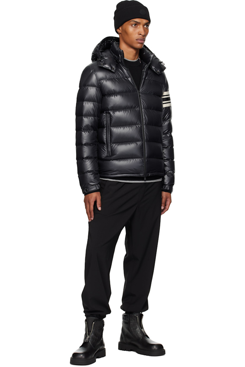 Down-filled and quilted polyester satin jacket.

· DIST-certified down
· Bungee-style drawstring at detachable hood
· Stand collar
· Two-way zip closure
· Zip pockets
· Bungee-style drawstring at hem
· Knit striped panel and felted logo patch at sleeve
· Elasticized cuffs
· Fully lined

Supplier color: Black

Fill: 90% goose down, 10% feather.