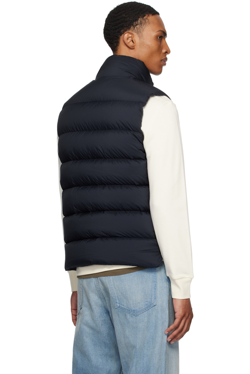 Down-filled and quilted recycled nylon longue saison vest.

· DIST-certified down
· Stand collar
· Two-way zip closure with press-stud placket
· Felted logo patch at chest
· Zip pockets
· Vented side seams
· Zip pocket at interior
· Fully lined

Supplier color: Obsidian blue

Fill: 90% goose down, 10% feather.