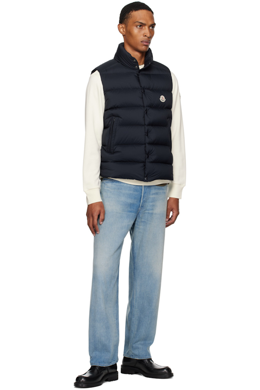 Down-filled and quilted recycled nylon longue saison vest.

· DIST-certified down
· Stand collar
· Two-way zip closure with press-stud placket
· Felted logo patch at chest
· Zip pockets
· Vented side seams
· Zip pocket at interior
· Fully lined

Supplier color: Obsidian blue

Fill: 90% goose down, 10% feather.