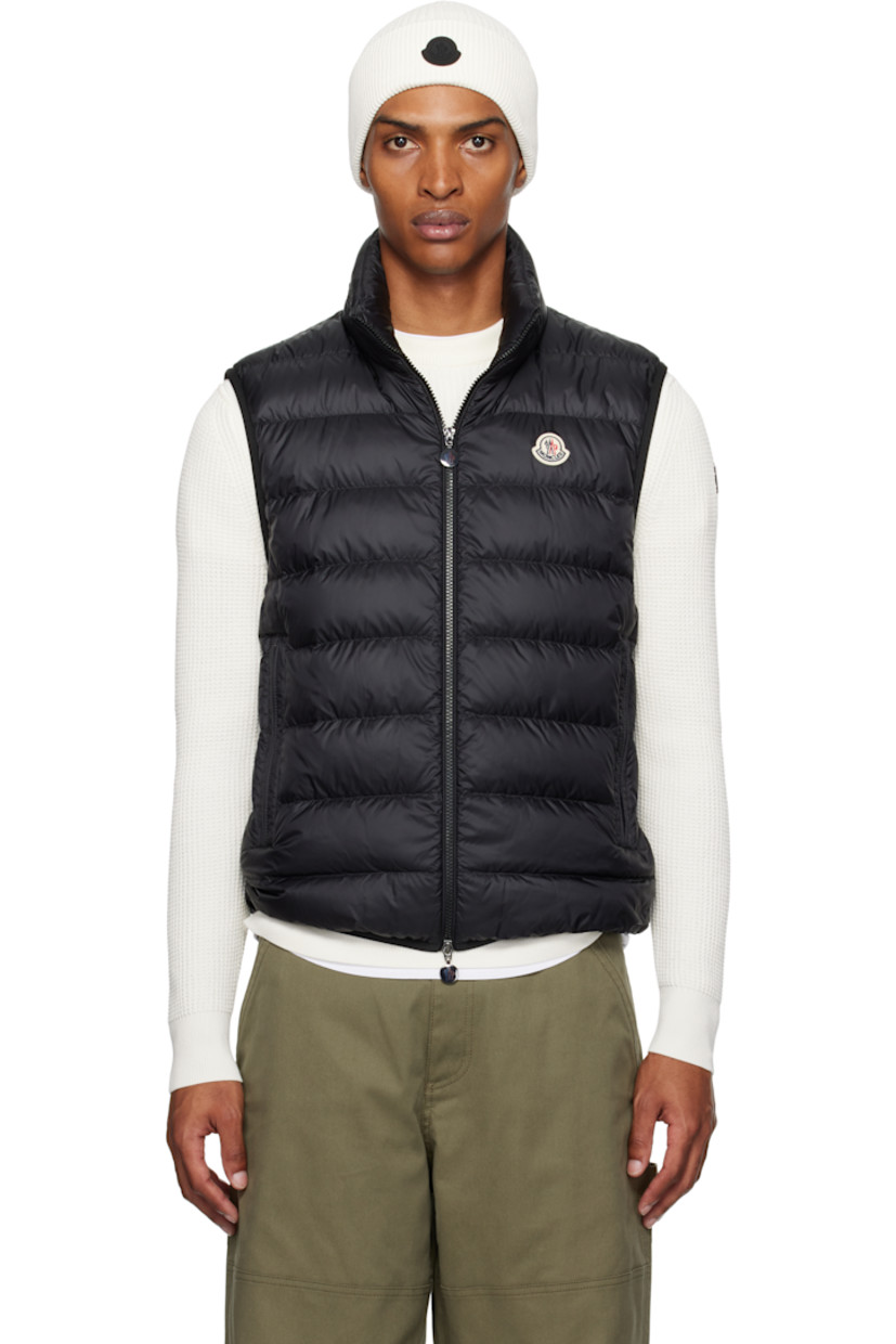 Down-filled and quilted nylon longue saison vest.

· DIST-certified down
· Lightweight
· Logo embroidered at stand collar
· Two-way zip closure
· Felted logo patch at chest
· Zip pockets
· Elasticized hem and armscyes
· Fully lined

Supplier color: Black

Fill: 90% goose down, 10% feather.