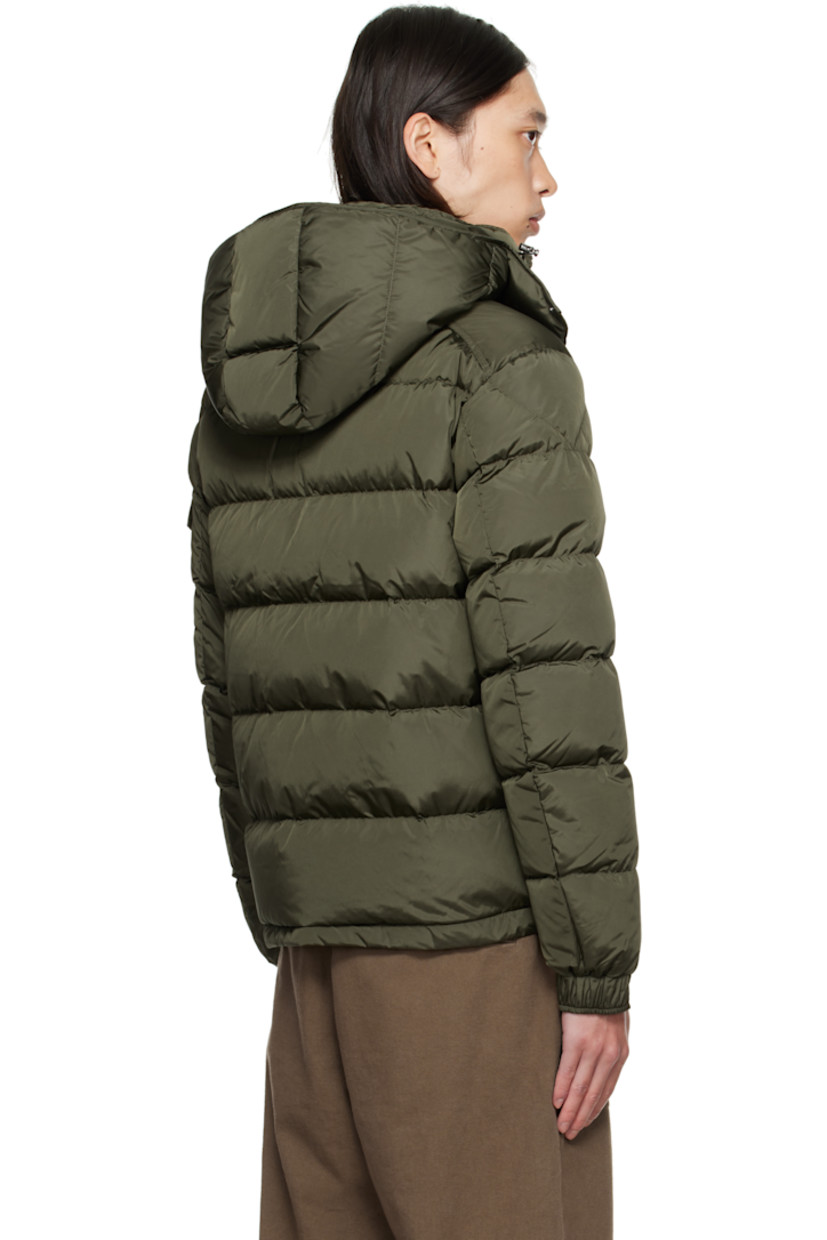 DIST-certified down-filled and quilted nylon satin jacket.

· Bungee-style drawstring at detachable hood
· Stand collar
· Two-way zip closure
· Zip pockets at front
· Bungee-style drawstring at hem
· Flap pocket and felted logo patch at sleeve
· Adjustable press-stud fastening at elasticized cuffs
· Zip pocket at interior
· Fully lined

Supplier color: Deep depths

Fill: 90% goose down, 10% feather.