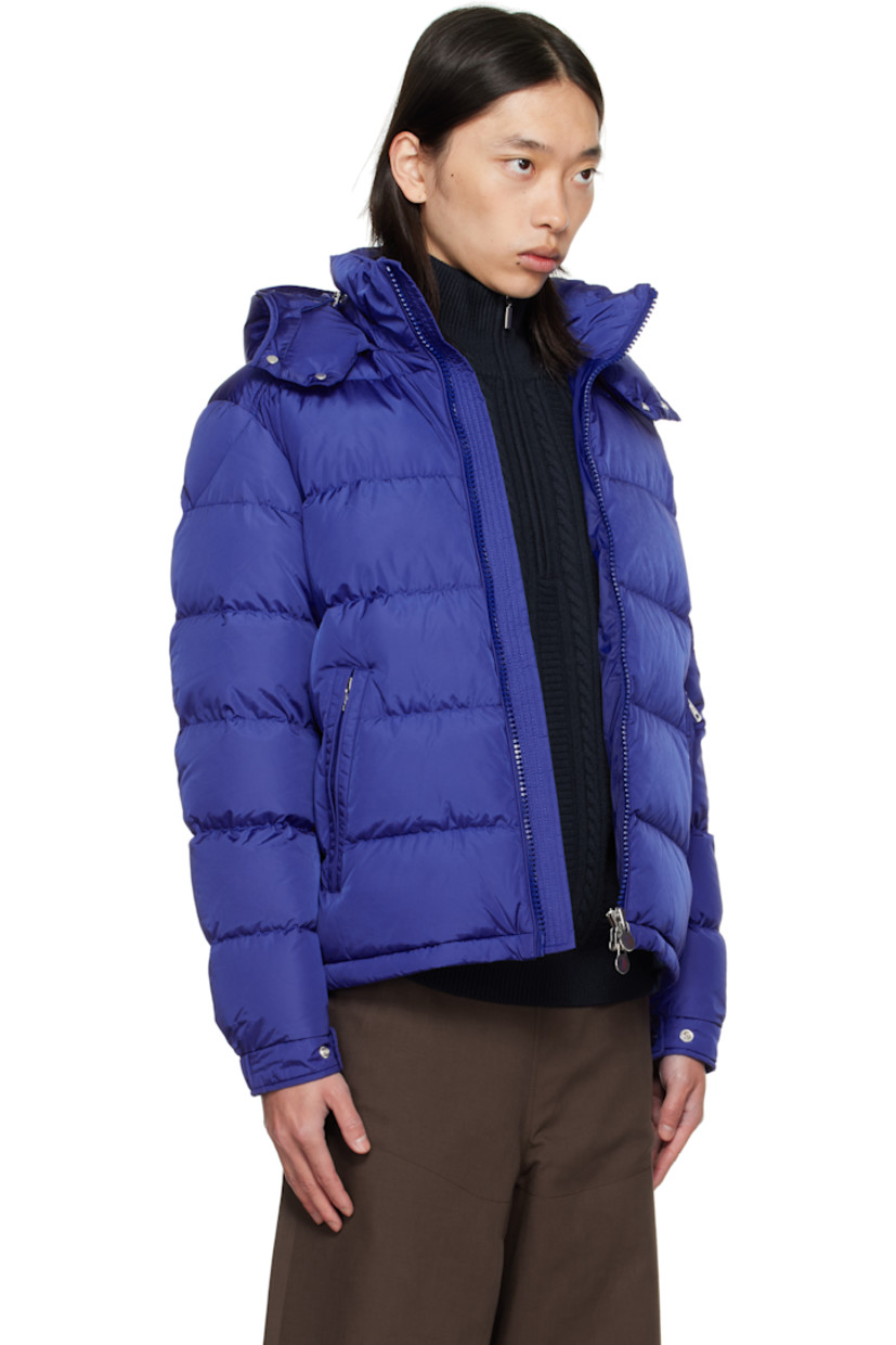 Down-filled quilted nylon satin jacket.

· DIST-certified down and feathers
· Bungee-style drawstring at detachable hood
· Funnel neck
· Two-way zip closure
· Zip pockets at waist
· Bungee-style drawstring at hem
· Flap pocket with embroidered logo at sleeve
· Adjustable press-stud tab at elasticized cuffs
· Zip pocket at interior
· Fully lined

Supplier color: Sodalite blue

Fill: 90% down, 10% feather.
