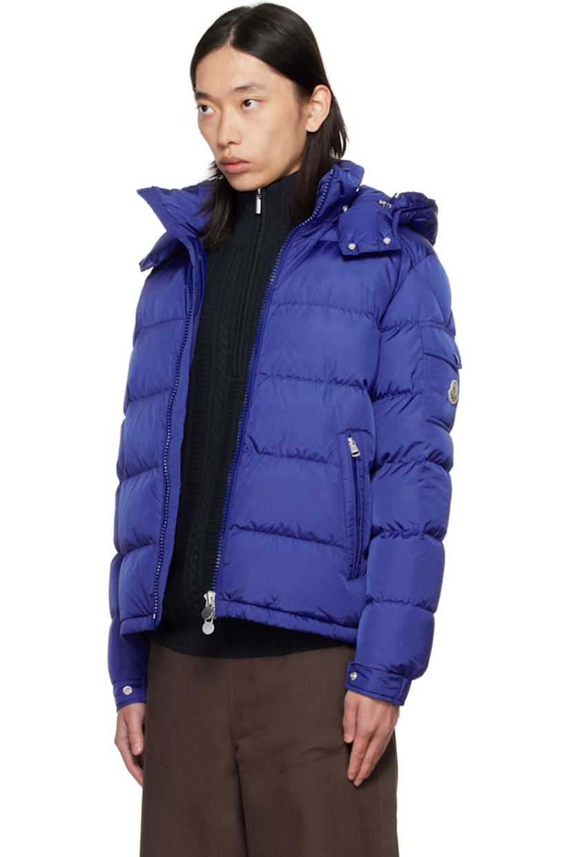 Down-filled quilted nylon satin jacket.

· DIST-certified down and feathers
· Bungee-style drawstring at detachable hood
· Funnel neck
· Two-way zip closure
· Zip pockets at waist
· Bungee-style drawstring at hem
· Flap pocket with embroidered logo at sleeve
· Adjustable press-stud tab at elasticized cuffs
· Zip pocket at interior
· Fully lined

Supplier color: Sodalite blue

Fill: 90% down, 10% feather.