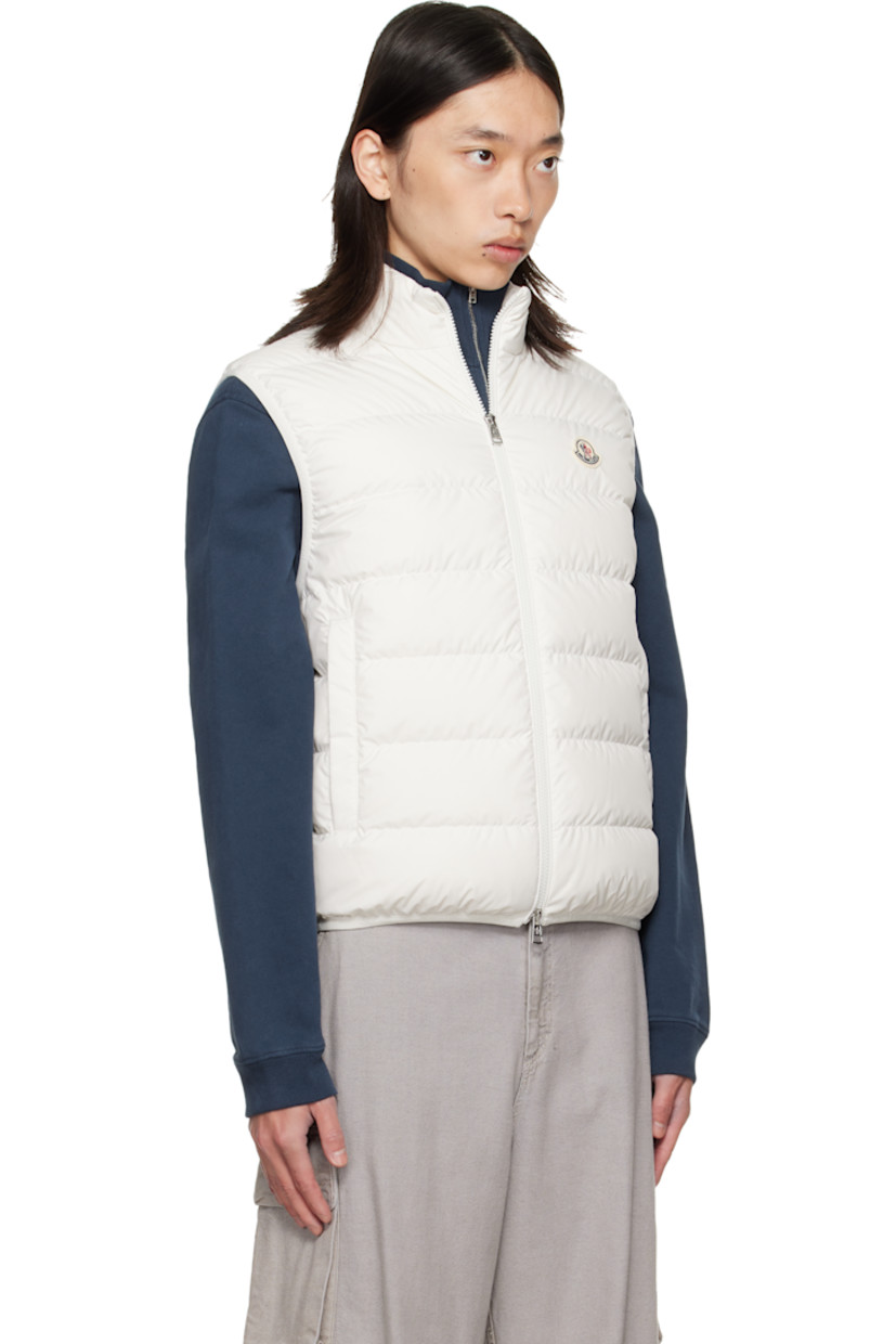 DIST-certified down-filled and quilted satin vest.

· Stand collar
· Two-way zip closure
· Felted logo patch at chest
· Welt pockets at front
· Logo-bonded elasticized hem and armscyes 
· Zip pocket at interior
· Fully lined

Supplier color: Silk white

Fill: 90% goose down, 10% feather.