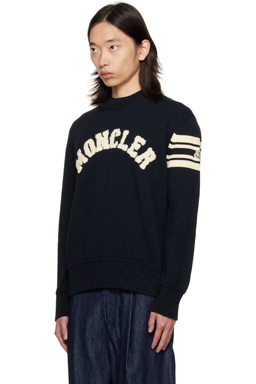 Knit cotton sweater. 

· Rib-knit crewneck, hem, and cuffs
· Bouclé logo appliqués at chest
· Tricolor felted logo patch and jacquard stripes at sleeve

Supplier color: Obsidian blue