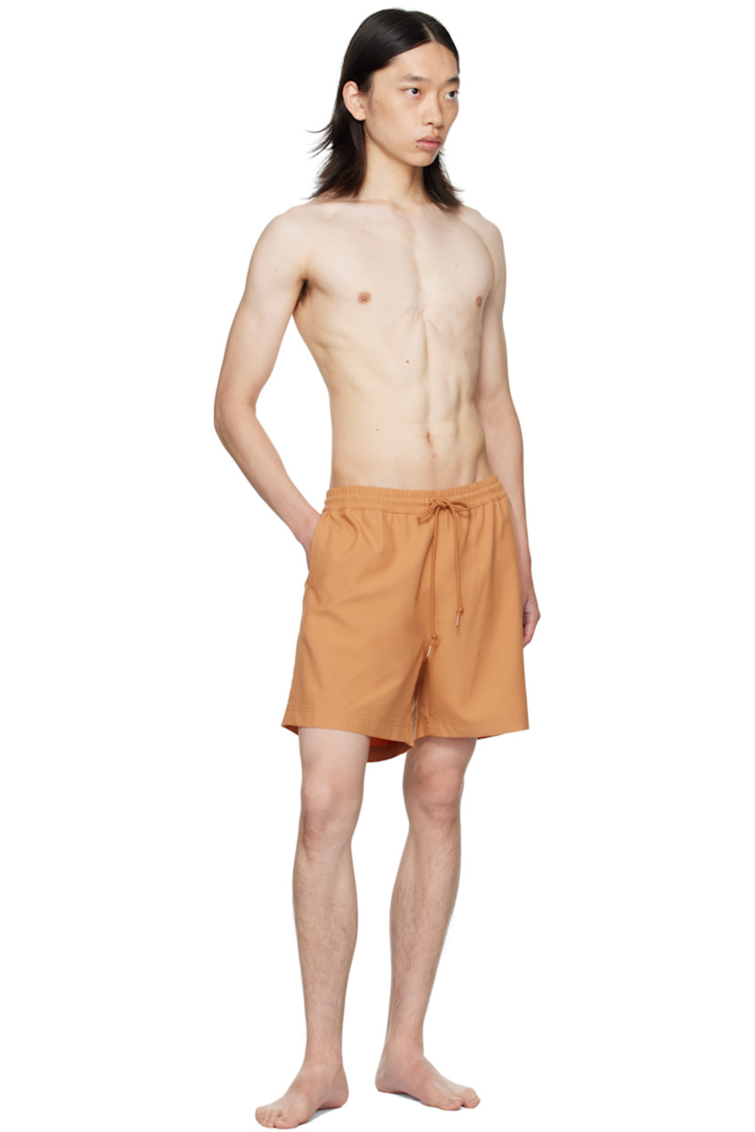 Satin swim shorts.

· Drawstring at elasticized waistband
· Three-pocket styling
· Logo embroidered at front cuff
· Mesh briefs-style lining

Supplier color: Redhaven