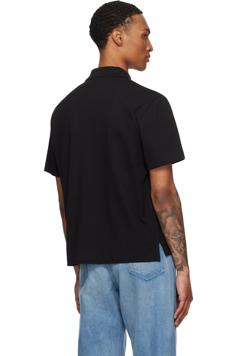 Organic cotton piqué polo.

· Rib-knit spread collar
· Concealed two-button placket
· Logo embroidered at chest
· Tennis-tail hem
· Logo patch at sleeve

Supplier color: Smoky black