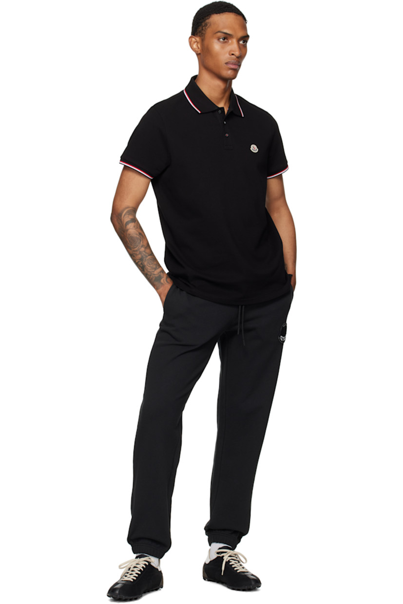 Slim-fit organic cotton piqué polo. 

· Tricolor striped rib-knit spread collar and cuffs
· Three-button placket
· Felted tricolor logo patch at chest
· Tennis-tail hem
· Logo-engraved hardware

Supplier color: Black