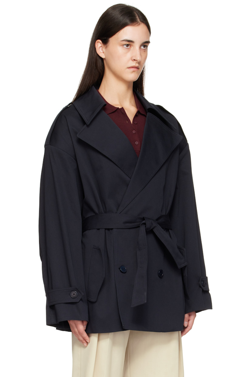 Stretch cotton gabardine trench coat.

· Notched lapel
· Double-breasted button closure
· Belt loops and detachable self-tie belt
· Flap pockets at waist
· Epaulets at padded shoulders
· Pleats at sleeves
· Button tab at cuffs
· Storm flap at back 
· Full satin lining

Supplier color: Dark navy