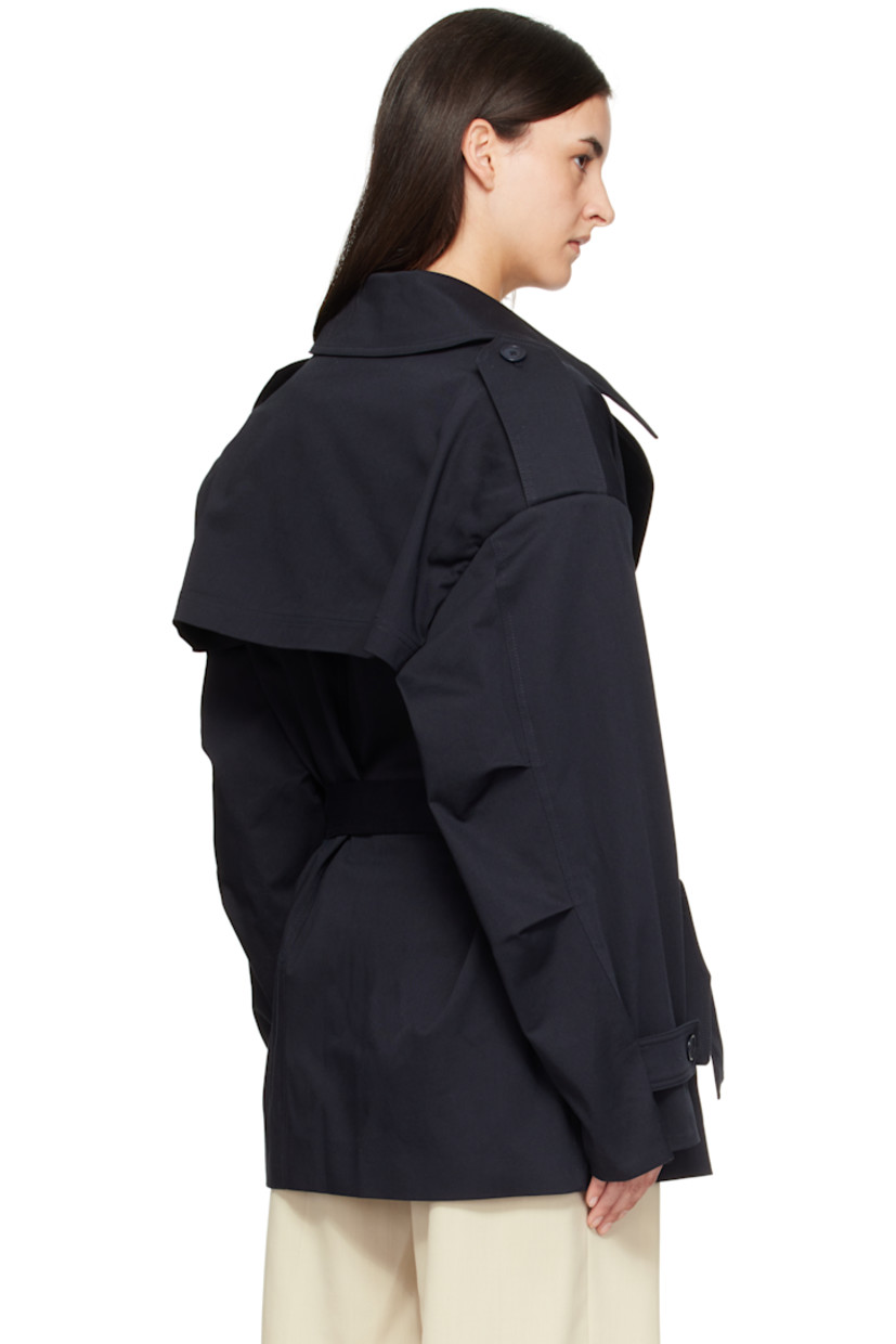 Stretch cotton gabardine trench coat.

· Notched lapel
· Double-breasted button closure
· Belt loops and detachable self-tie belt
· Flap pockets at waist
· Epaulets at padded shoulders
· Pleats at sleeves
· Button tab at cuffs
· Storm flap at back 
· Full satin lining

Supplier color: Dark navy