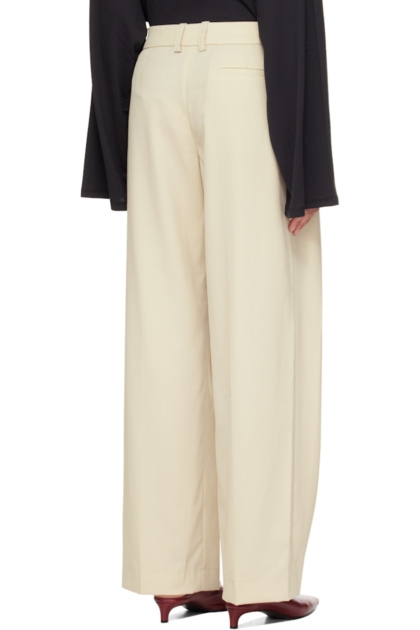 Virgin wool-blend twill trousers.

· Wide-leg
· High-rise
· Belt loops
· Three-pocket styling
· Zip fly
· Pleats at front
· Creased legs

Supplier color: Cement