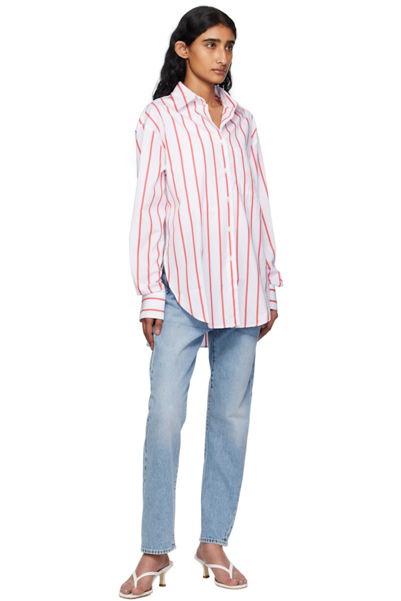 Lightweight cotton poplin shirt.

· Stripes throughout
· Spread collar
· Button closure
· Patch pocket at chest
· Shirttail hem
· Vented side seams 
· Dropped shoulders 
· Logo embroidered at cuff
· Barrel cuffs
· Twin pleats at back yoke

Supplier color: White/Red stripe