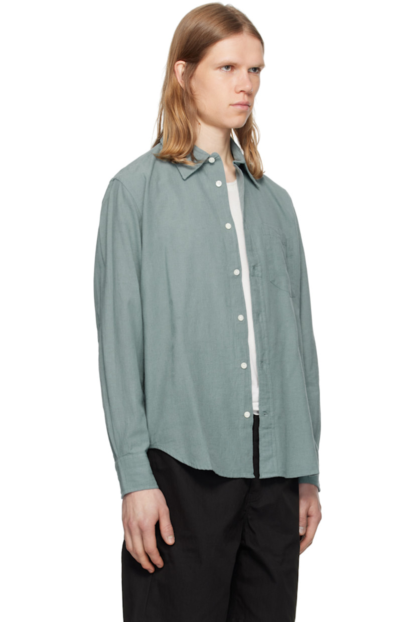 Lightweight cotton- and linen-blend chambray shirt.

· Spread collar
· Button closure
· Patch pocket
· Shirttail hem
· Adjustable buttoned barrel cuffs
· Box pleat at back yoke
· Mother-of-pearl hardware

Supplier color: Greyish blue