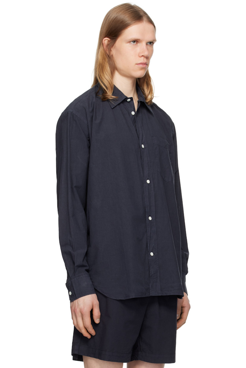 Cotton- and tencel-blend poplin shirt.

· Spread collar
· Button closure
· Patch pocket
· Shirttail hem
· Adjustable buttoned barrel cuffs
· Box pleat at back yoke
· Mother-of-pearl hardware

Supplier color: Dark navy