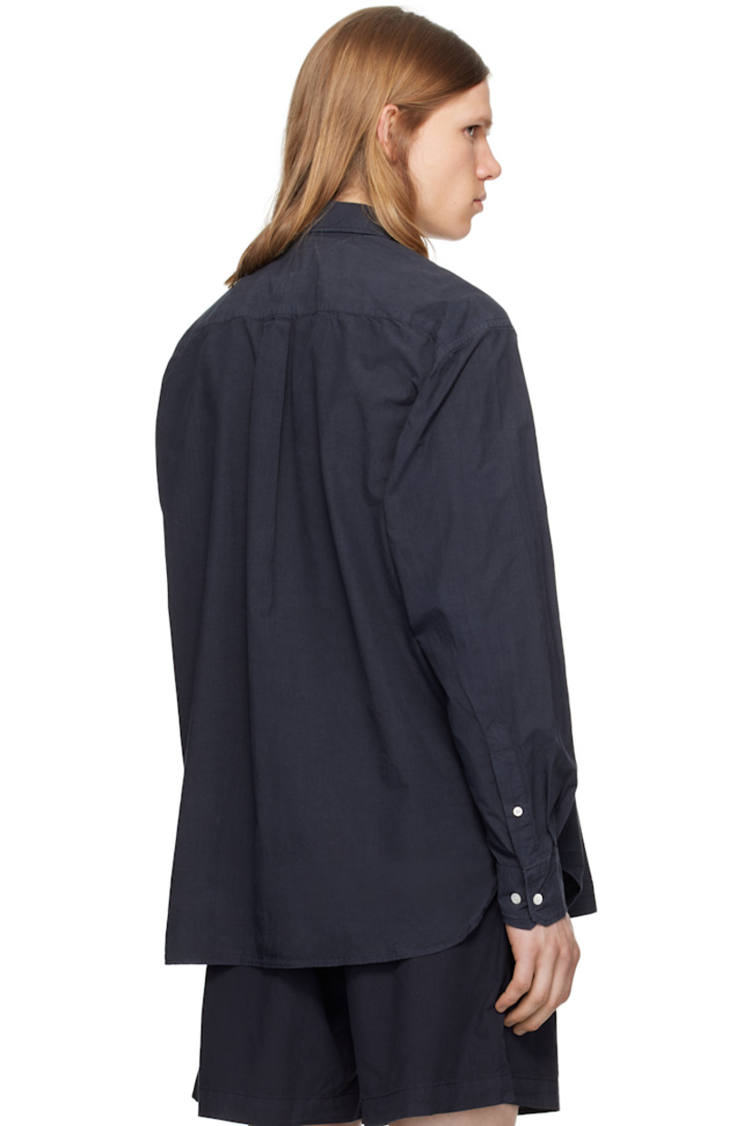 Cotton- and tencel-blend poplin shirt.

· Spread collar
· Button closure
· Patch pocket
· Shirttail hem
· Adjustable buttoned barrel cuffs
· Box pleat at back yoke
· Mother-of-pearl hardware

Supplier color: Dark navy
