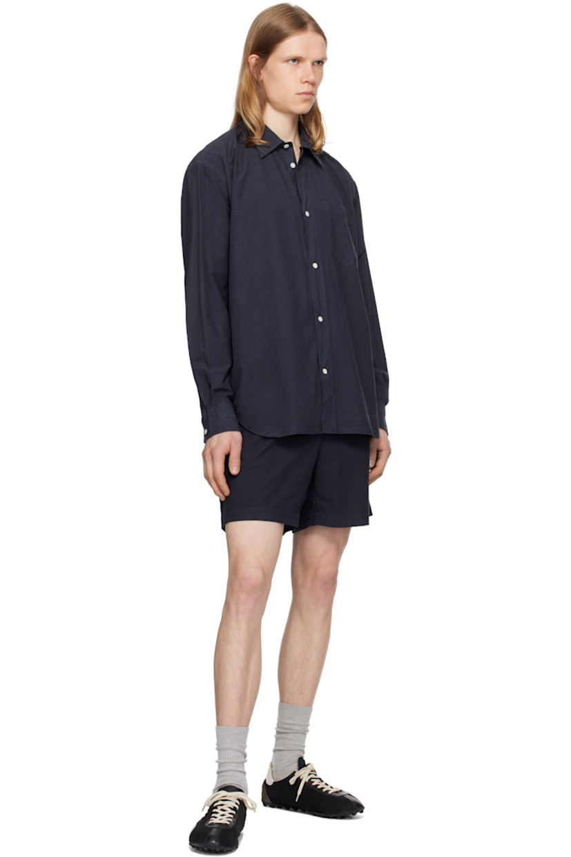 Cotton- and tencel-blend poplin shirt.

· Spread collar
· Button closure
· Patch pocket
· Shirttail hem
· Adjustable buttoned barrel cuffs
· Box pleat at back yoke
· Mother-of-pearl hardware

Supplier color: Dark navy
