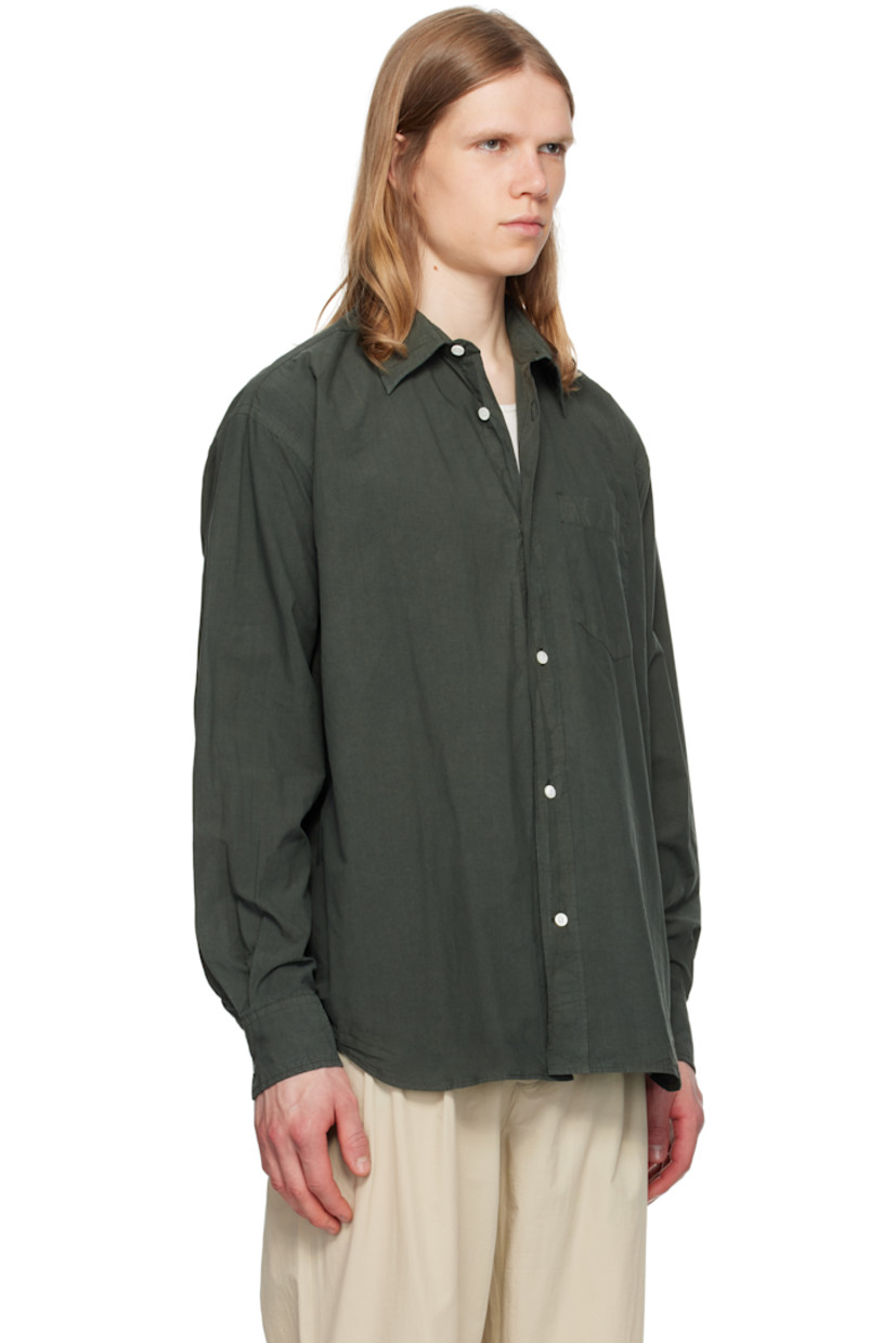 Cotton- and tencel-blend poplin shirt.

· Spread collar
· Button closure
· Patch pocket
· Shirttail hem
· Adjustable buttoned barrel cuffs
· Box pleat at back yoke
· Mother-of-pearl hardware

Supplier color: Black olive