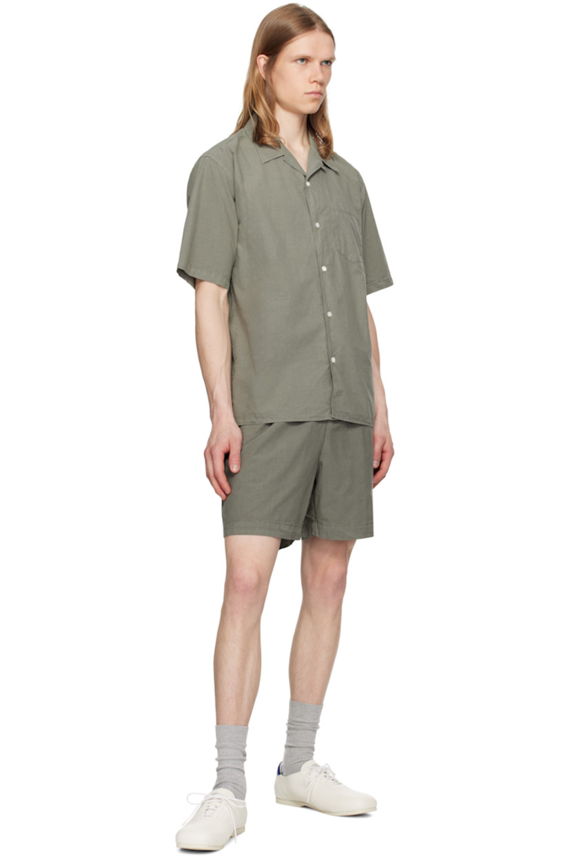 Garment-dyed cotton- and tencel-blend poplin shirt.

· Open spread collar
· Button closure
· Patch pocket
· Mother-of-pearl hardware

Supplier color: Mid khaki
