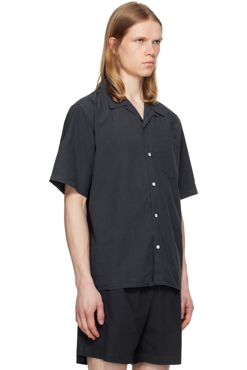 Garment-dyed cotton- and tencel-blend poplin shirt.

· Open spread collar
· Button closure
· Patch pocket
· Mother-of-pearl hardware

Supplier color: Dark navy