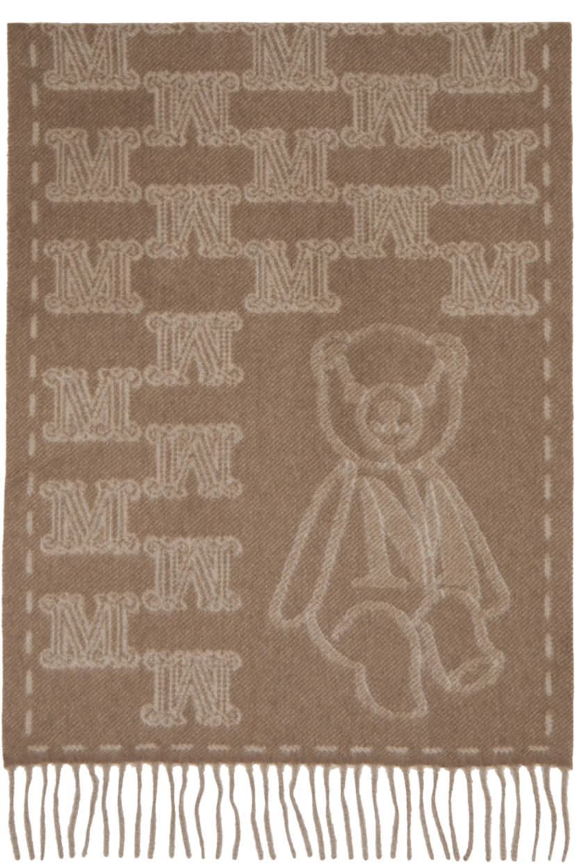 Rectangular cashmere flannel scarf.

· Jacquard logo pattern throughout
· Jacquard graphic at face
· Fringed detailing at ends
· L71" x W19"

Supplier color: Beige