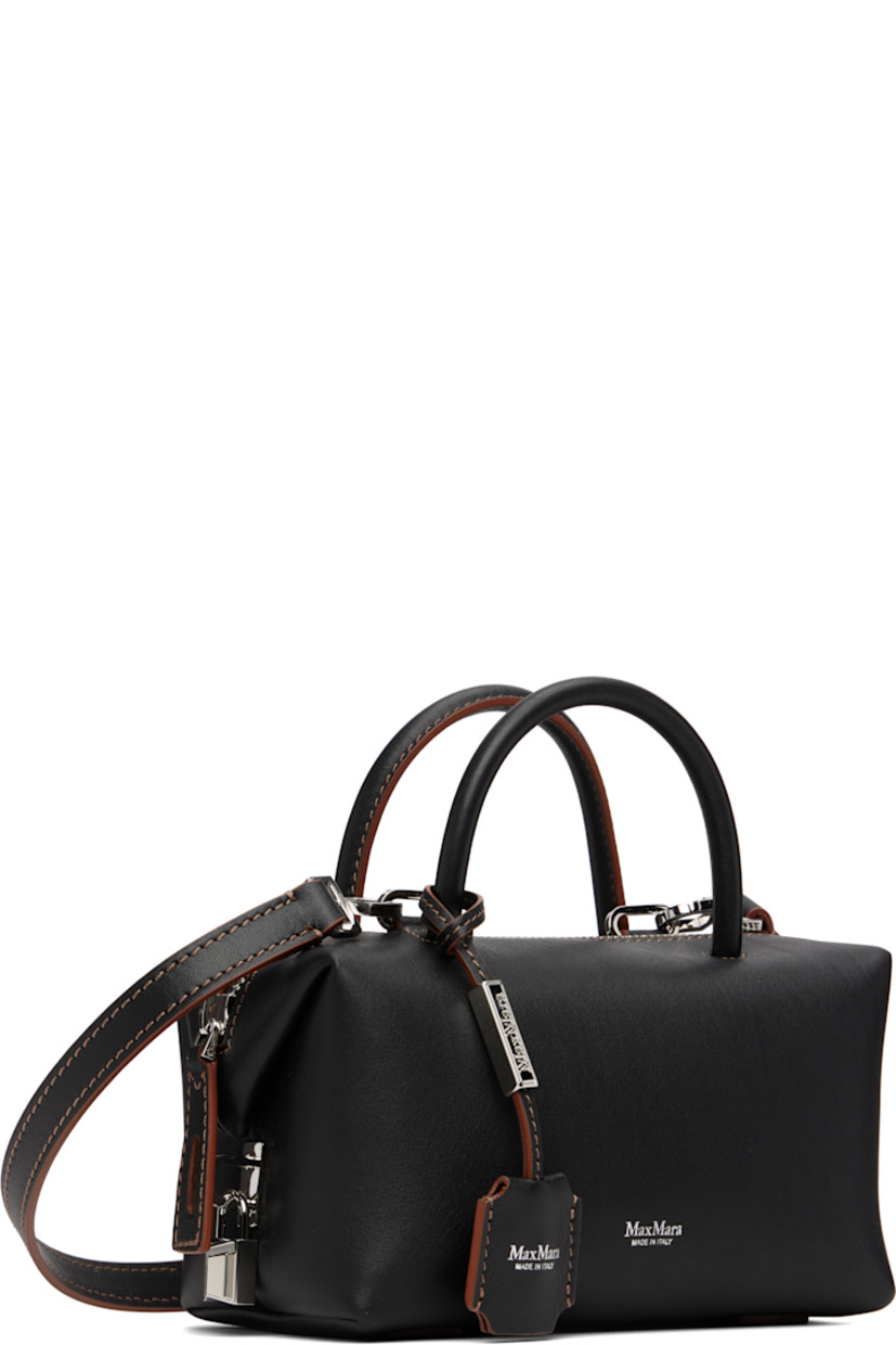 Buffed calfskin top handle bag.

· Rolled carry handles
· Detachable sheathed keys at handle
· Detachable crossbody strap
· Logo stamp at face
· Bumper pads at base
· Padlock at side
· Zip closure
· Card slot at interior
· Goatskin suede lining
· H4" x W7" x D4"

Supplier color: Black