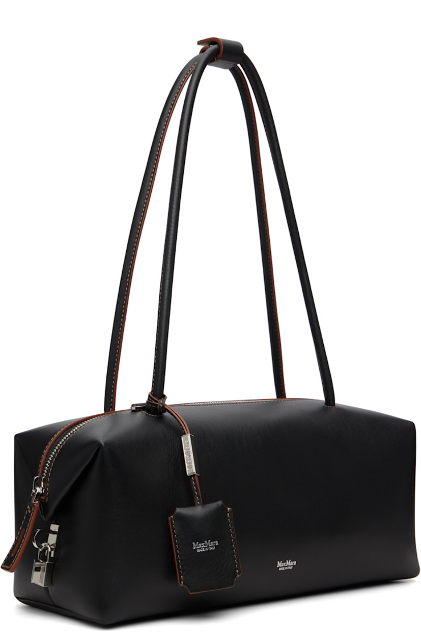Buffed calfskin shoulder bag.

· Press-stud tab at rolled shoulder straps
· Detachable leather sheathed keys with logo plaque
· Logo stamp at face
· Padlock at side
· Bumper pads at base
· Zip closure
· Patch pocket at goatskin suede interior
· H5" x W11.5" x D5"

Supplier color: Black