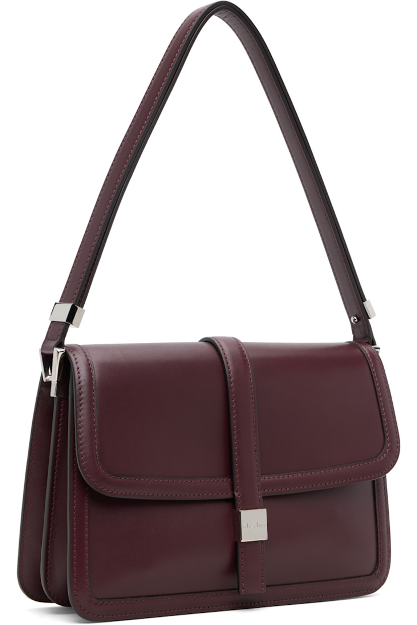 Buffed calfskin shoulder bag.

· Adjustable shoulder strap
· Accordion panels at sides
· Patch pocket at back face
· Logo plaque at magnetic press-stud flap
· Zip pocket at two-compartment interior
· Goatskin suede lining
· H7" x W10.75" x D2.5"

Supplier color: Bordeaux