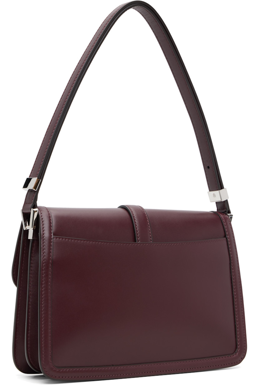 Buffed calfskin shoulder bag.

· Adjustable shoulder strap
· Accordion panels at sides
· Patch pocket at back face
· Logo plaque at magnetic press-stud flap
· Zip pocket at two-compartment interior
· Goatskin suede lining
· H7" x W10.75" x D2.5"

Supplier color: Bordeaux