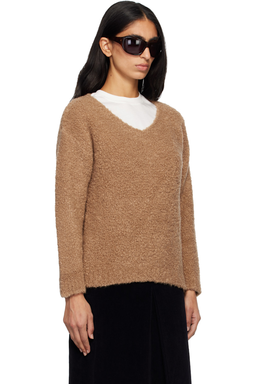 Bouclé-knit camel wool- and silk-blend sweater. Rib-knit V-neck, hem, and cuffs.

Supplier color: Camel