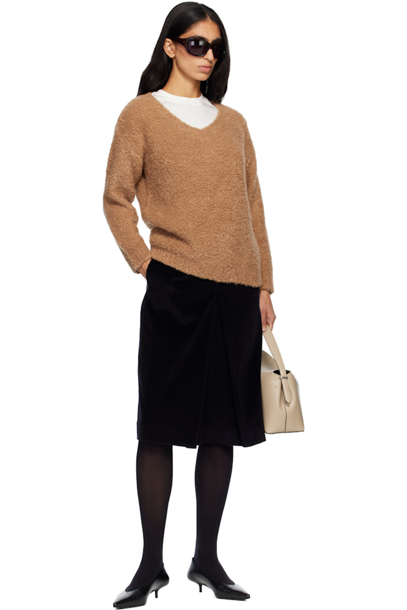 Bouclé-knit camel wool- and silk-blend sweater. Rib-knit V-neck, hem, and cuffs.

Supplier color: Camel