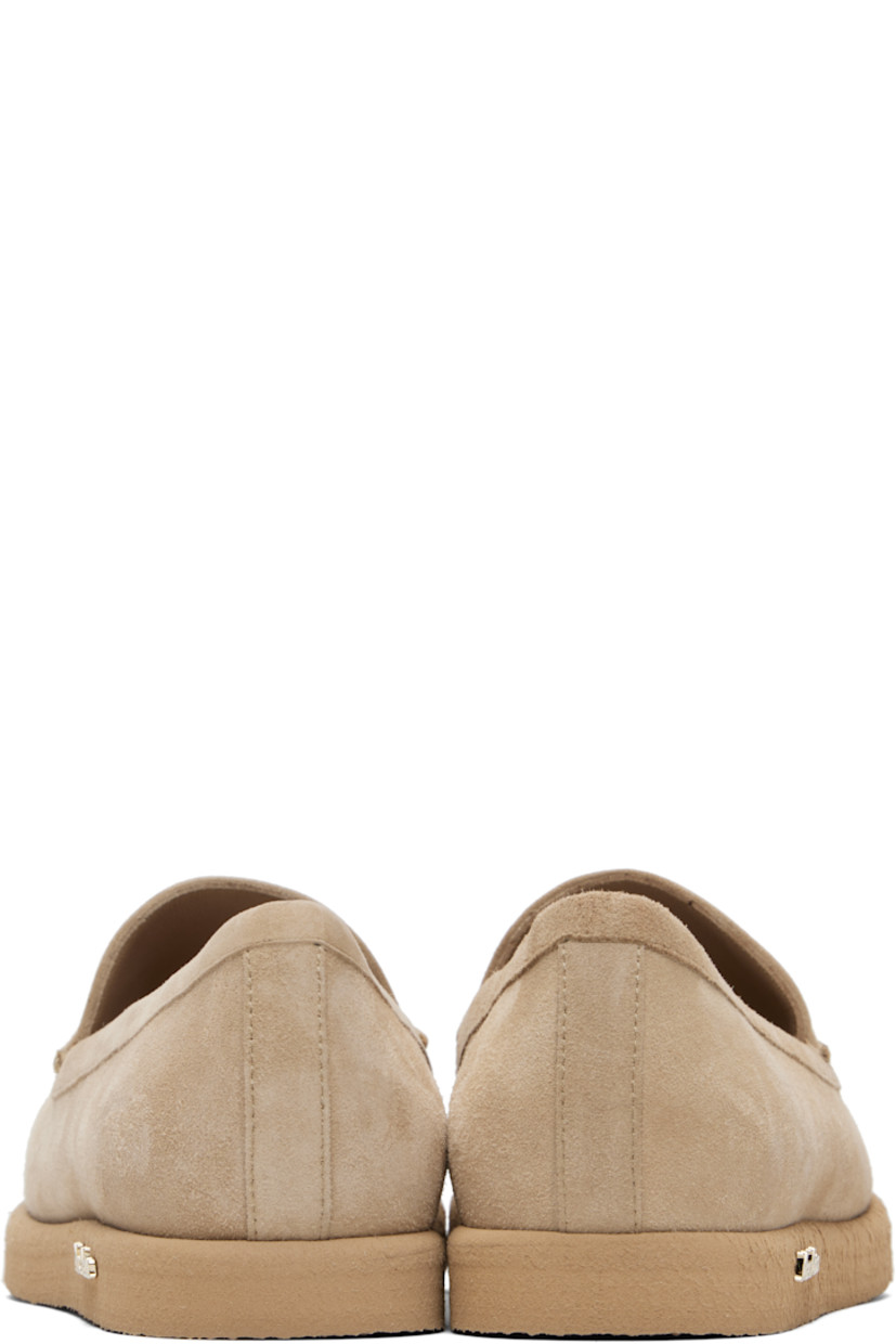 Goatskin suede slip-on loafers. 

· Moc toe
· Strap at vamp
· Lambskin nubuck and satin lining  
· Logo hardware at outer side
· Crêpe-rubber sole 

Supplier color: Camel