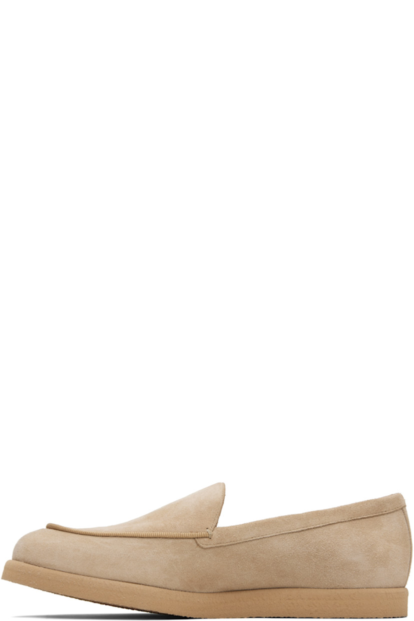 Goatskin suede slip-on loafers. 

· Moc toe
· Strap at vamp
· Lambskin nubuck and satin lining  
· Logo hardware at outer side
· Crêpe-rubber sole 

Supplier color: Camel