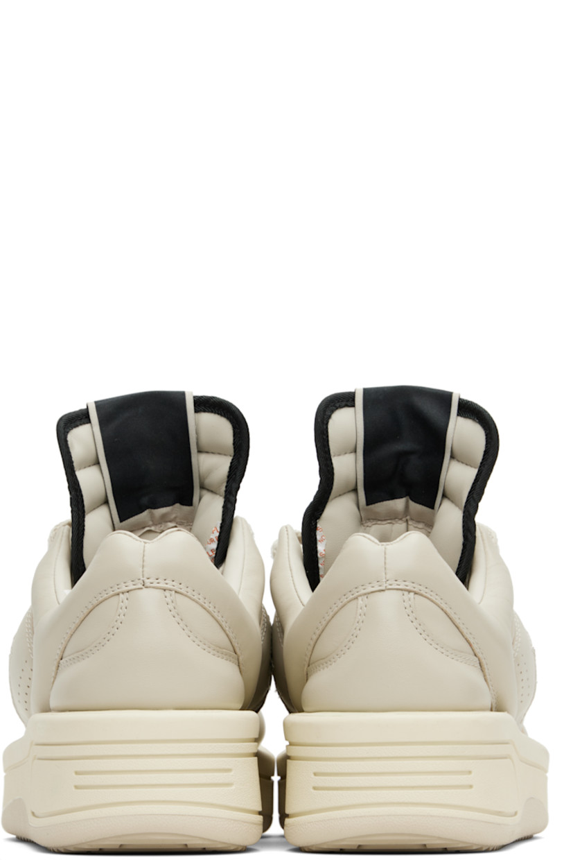 Low-top buffed leather sneakers in off-white.

· Perforated detailing at toe and sides
· Lace-up closure
· Logo flag at extended padded tongue
· Padded collar
· Logo cutout at sides
· Buffed faux-leather lining
· Treaded rubber platform sole
· Platform: H1.5"

Part of the Rick Owens Drkshdw x Converse collaboration.

Supplier color: Oyster/Black