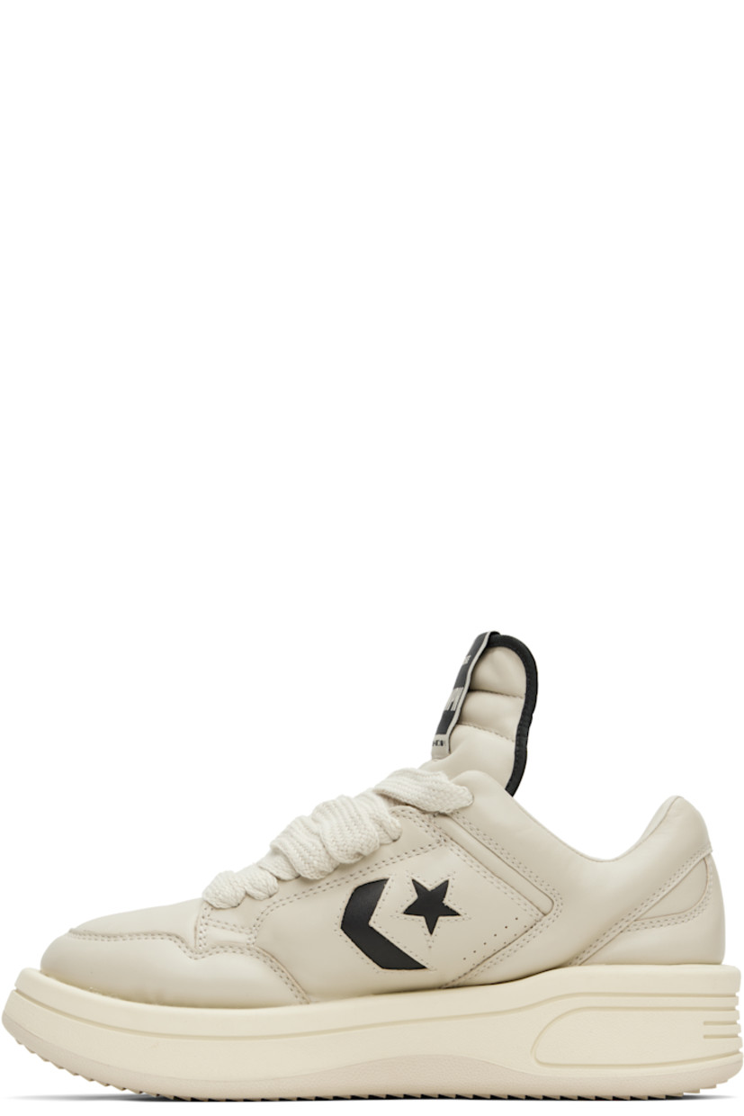 Low-top buffed leather sneakers in off-white.

· Perforated detailing at toe and sides
· Lace-up closure
· Logo flag at extended padded tongue
· Padded collar
· Logo cutout at sides
· Buffed faux-leather lining
· Treaded rubber platform sole
· Platform: H1.5"

Part of the Rick Owens Drkshdw x Converse collaboration.

Supplier color: Oyster/Black