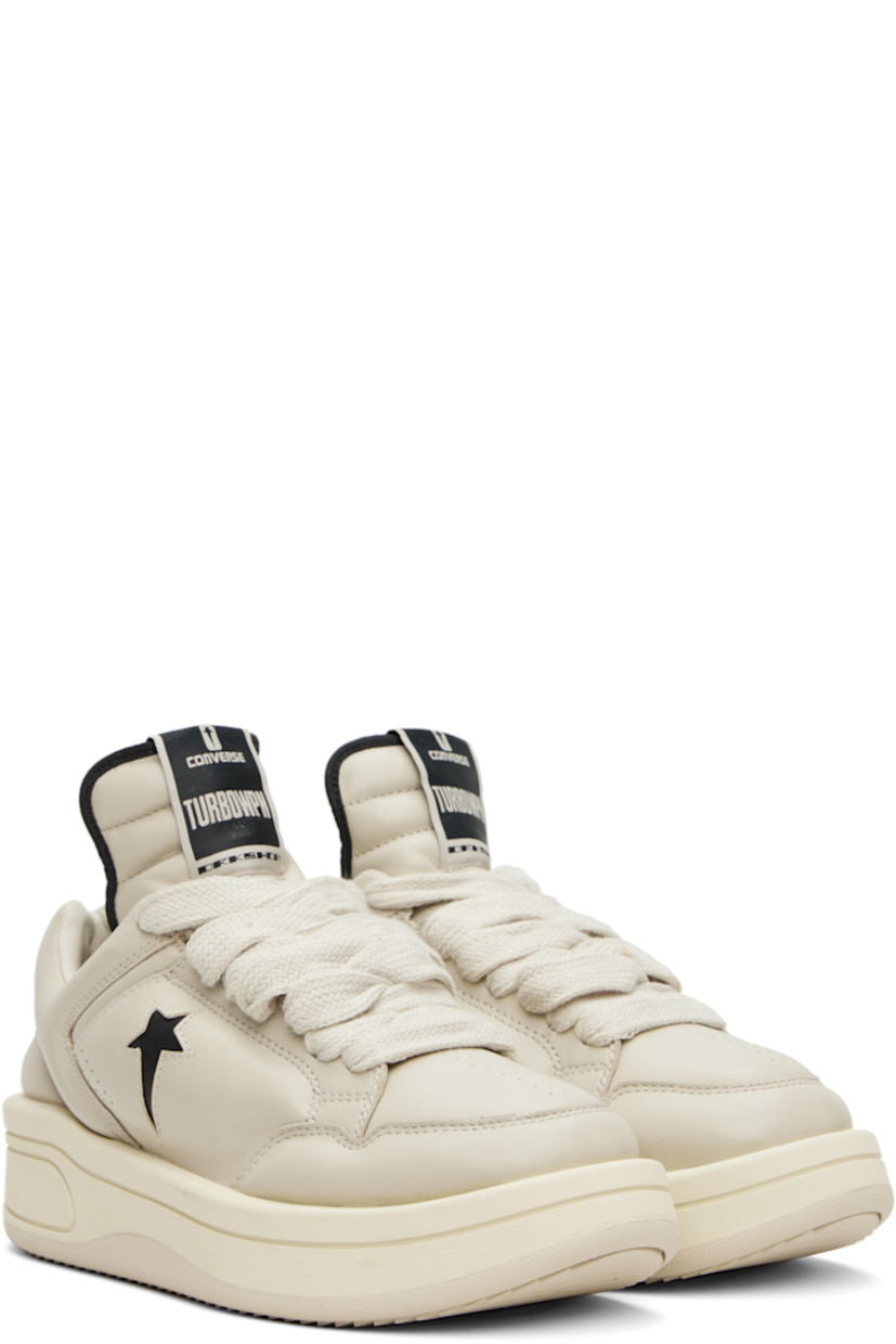 Low-top buffed leather sneakers in off-white.

· Perforated detailing at toe and sides
· Lace-up closure
· Logo flag at extended padded tongue
· Padded collar
· Logo cutout at sides
· Buffed faux-leather lining
· Treaded rubber platform sole
· Platform: H1.5"

Part of the Rick Owens Drkshdw x Converse collaboration.

Supplier color: Oyster/Black
