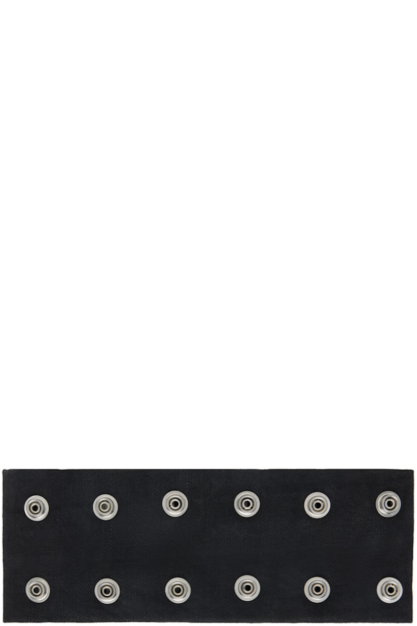 Waxed 13 oz non-stretch denim choker. 

· Overdyed and ZDHC-certified 
· Press-stud fastenings throughout 
· Plain-woven cotton lining 
· L20" x W3.25"

Supplier color: Black wax