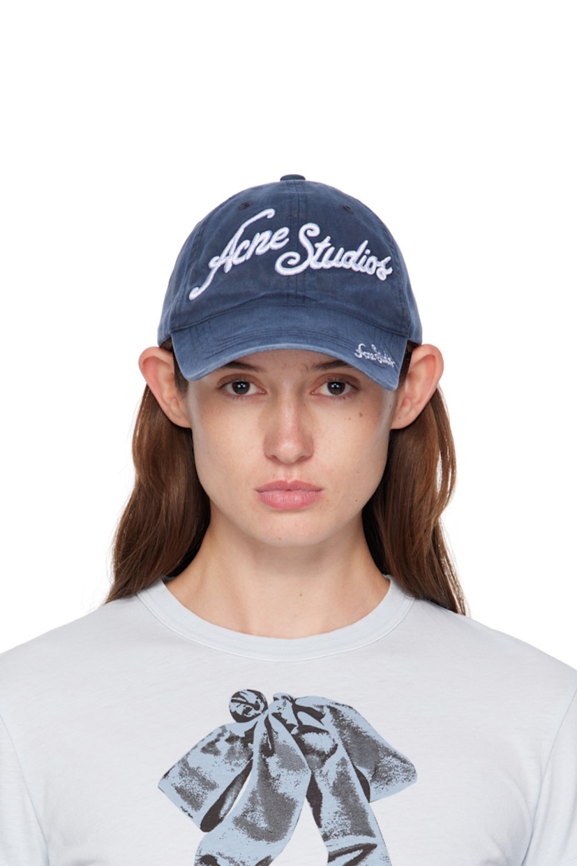Cotton twill cap. 

· Fading throughout 
· Embroidered eyelets at crown
· Embroidered logo at face and curved brim 
· Cinch fastening at back
· Twill browband

Supplier color: Deep blue
