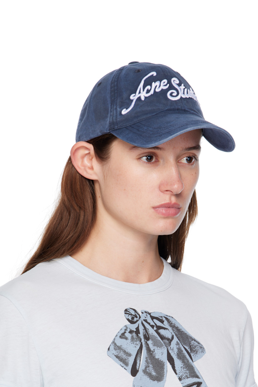Cotton twill cap. 

· Fading throughout 
· Embroidered eyelets at crown
· Embroidered logo at face and curved brim 
· Cinch fastening at back
· Twill browband

Supplier color: Deep blue
