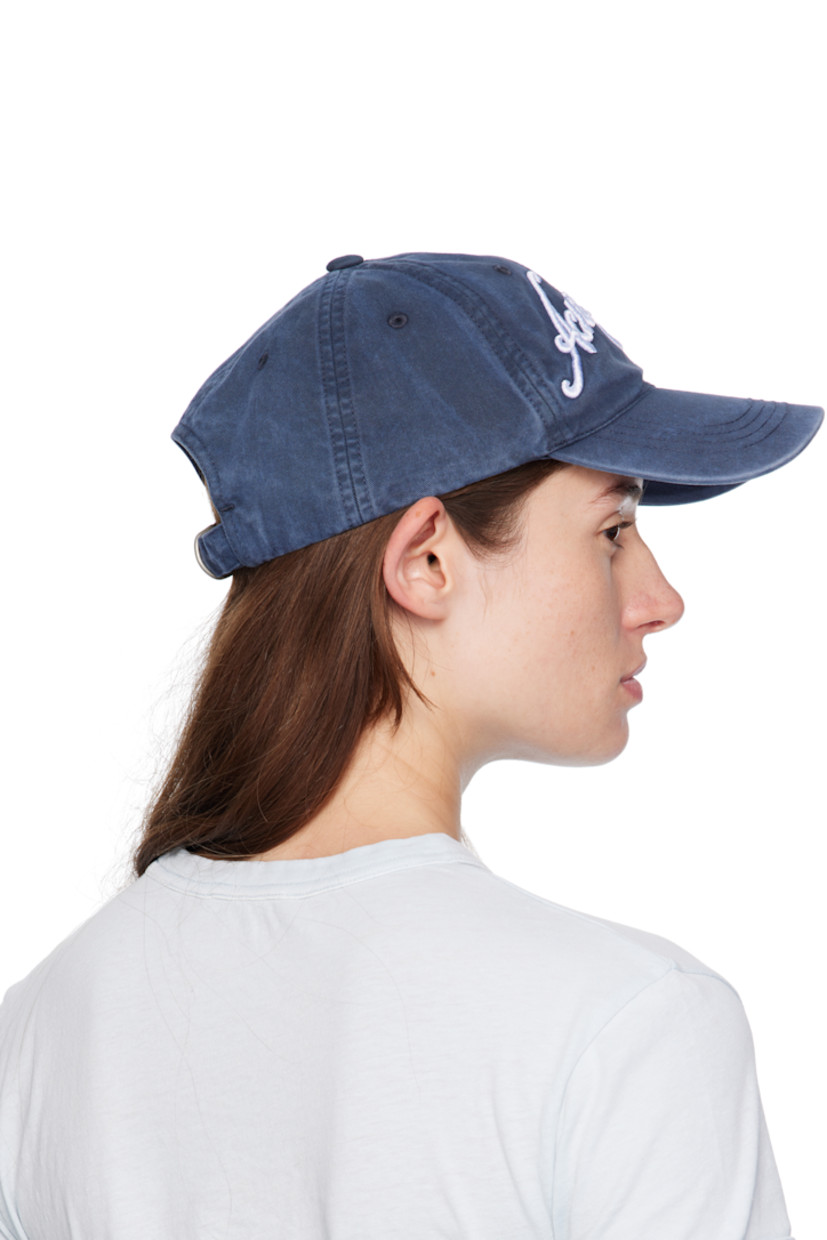 Cotton twill cap. 

· Fading throughout 
· Embroidered eyelets at crown
· Embroidered logo at face and curved brim 
· Cinch fastening at back
· Twill browband

Supplier color: Deep blue