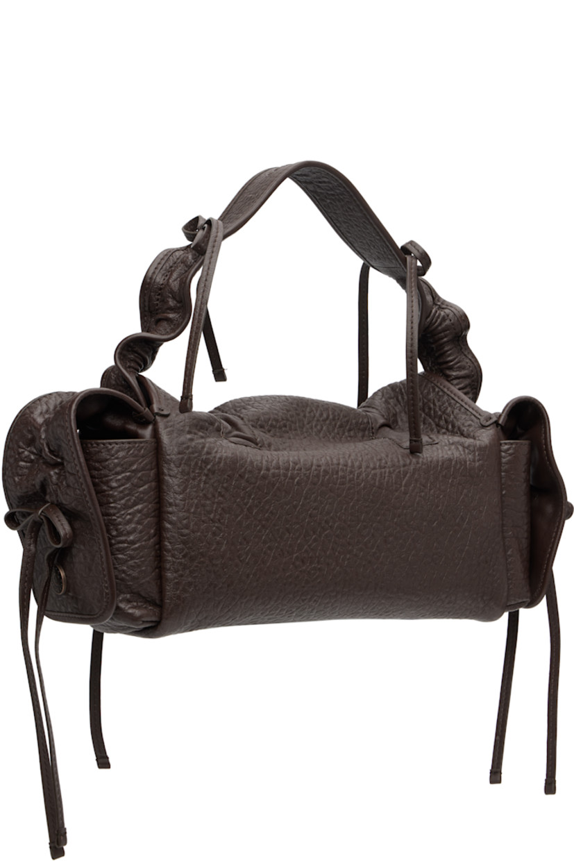 Grained nappa lambskin top handle bag.

· Bows and ruching throughout
· Embossed logo at adjustable shoulder strap
· Logo charm at face
· Flap pocket at sides
· Magnetic flap
· Patch pocket at interior
· Logo-engraved antiqued copper-tone hardware
· H6.5" x W14" x D4"

Supplier color: Chocolate brown