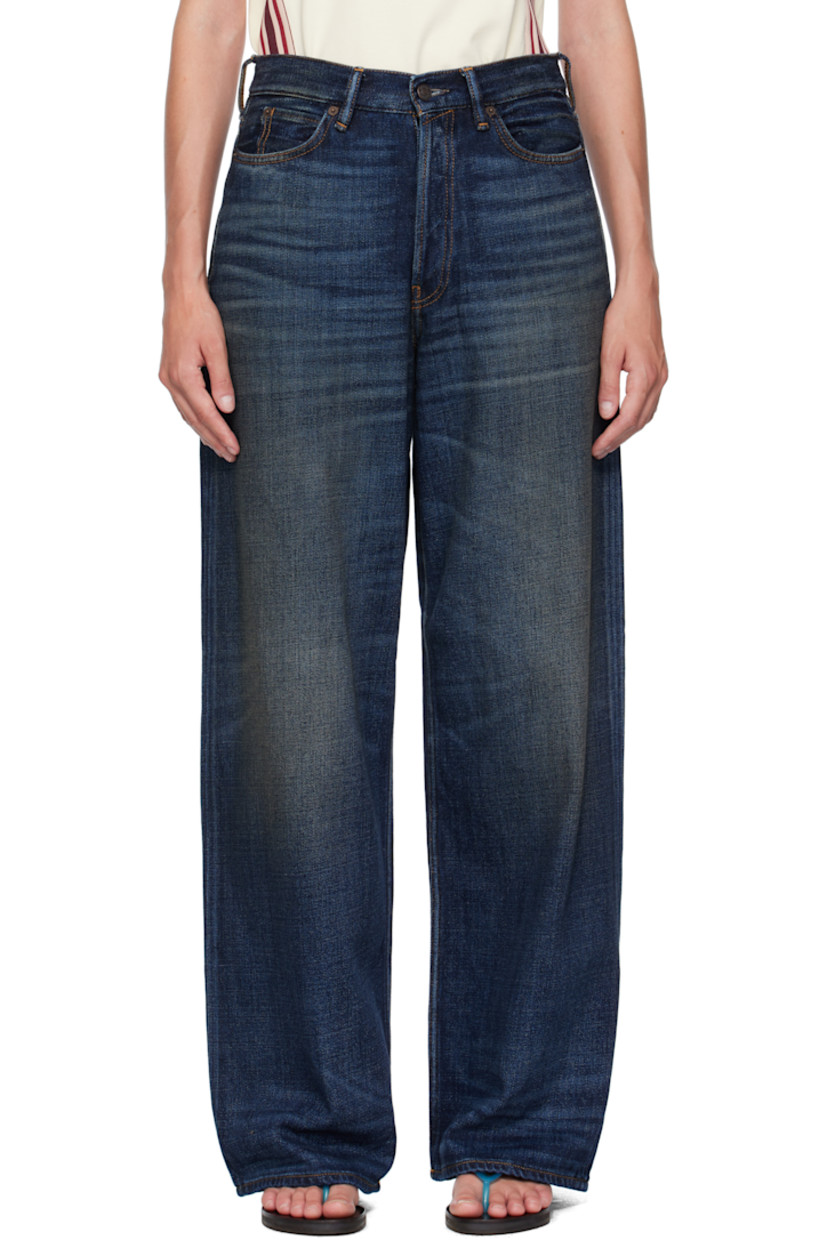 Non-stretch organic cotton denim jeans.

· Fading, smudging, and whiskering throughout
· Loose-fit
· Belt loops
· Five-pocket styling
· Button fly
· Logo patch at back waistband 
· Contrast stitching in tan

Supplier color: Dark blue