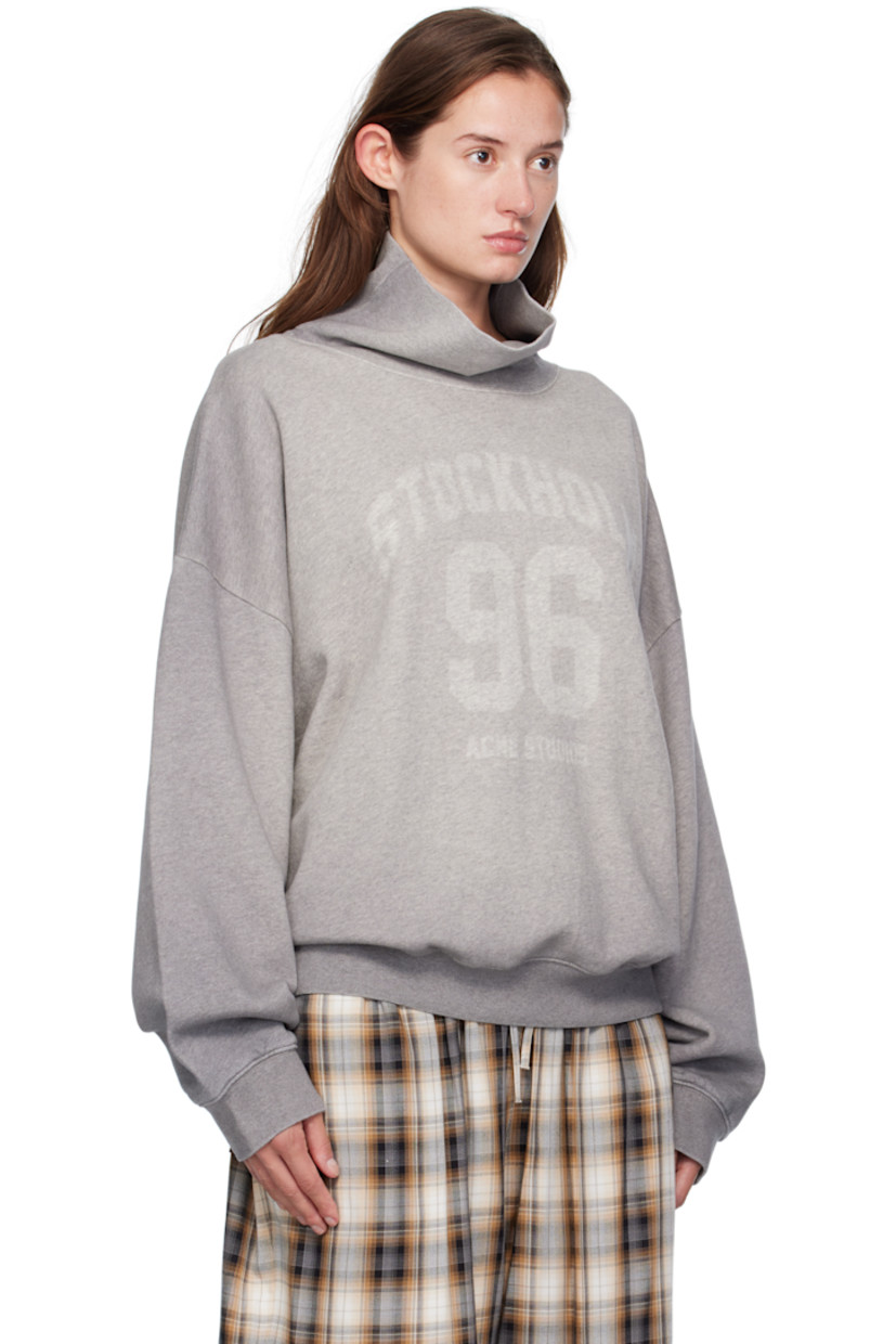 Organic cotton fleece turtleneck.

· GOTS-certified organic cotton
· Fading throughout
· Rib-knit collar, hem, and cuffs
· Faded text and logo printed at front
· Dropped shoulders

Supplier color: Grey melange