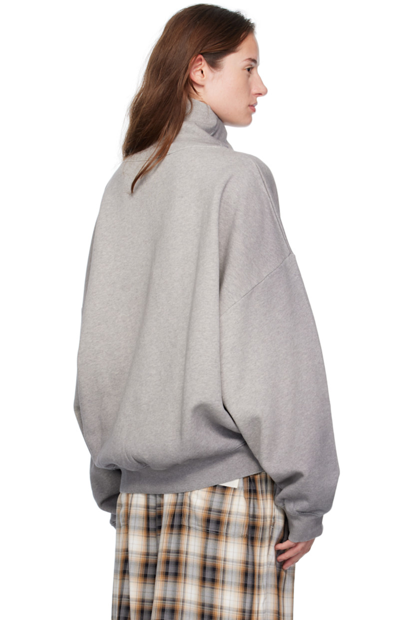 Organic cotton fleece turtleneck.

· GOTS-certified organic cotton
· Fading throughout
· Rib-knit collar, hem, and cuffs
· Faded text and logo printed at front
· Dropped shoulders

Supplier color: Grey melange